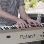 Guy playing an electric keyboard