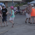 Adults dancing and walking around at a Bel Air Festival