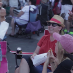 A family sitting in chairs outside at a Bel Air event